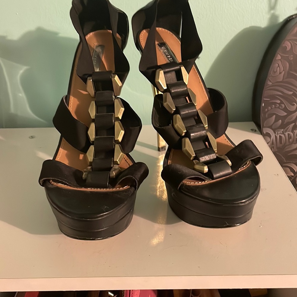 Black straps heels with gold accents